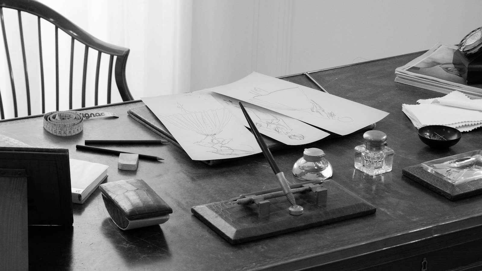 A black and white photo of a desk and chair